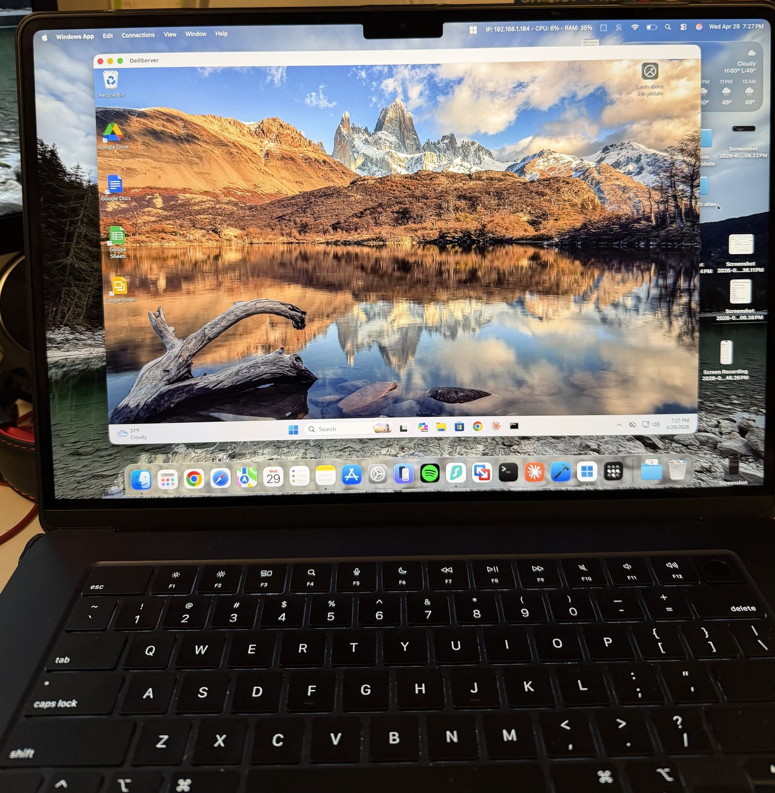 A MacBook screen showing Microsoft's Windows App with an active Remote Desktop session into a Windows 11 machine — Patagonia mountain wallpaper visible on the remote desktop.